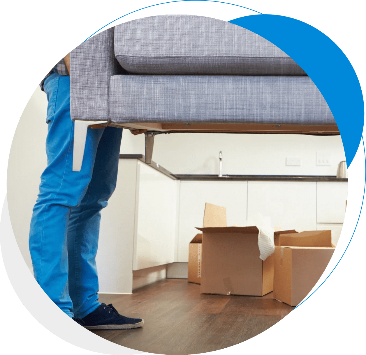 5 A person holding the back of a couch in a room.